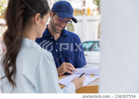 Delivery express courier young man use giving boxes or Food to woman customer at front home. Delivery express courier young man use giving boxes or Food to woman customer at front home. 136307554