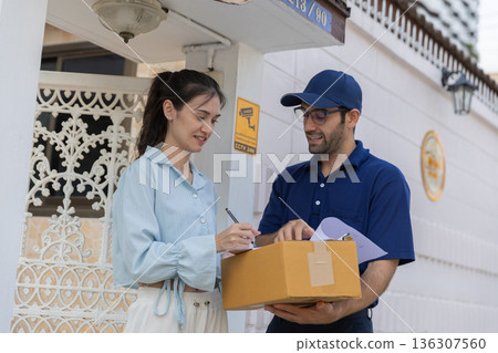 Delivery express courier young man use giving boxes or Food to woman customer at front home. Delivery express courier young man use giving boxes or Food to woman customer at front home. 136307560