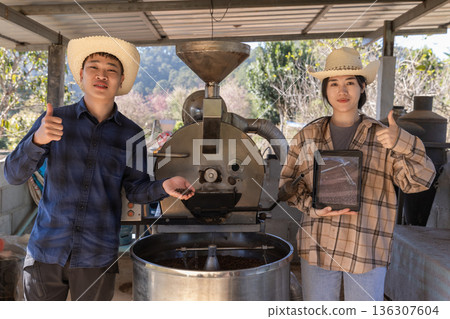 Coffee processing. Coffee roasting machine with arabica beans in stainless steel cooling bin. 136307604