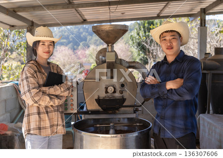 Coffee processing. Coffee roasting machine with arabica beans in stainless steel cooling bin. 136307606