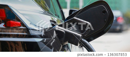 Electric car charging station. Hybrid car Electric charger station in the Car Park. Electric car charging station. Hybrid car Electric charger station in the Car Park. 136307853
