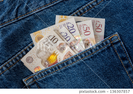 Jeans with british pound money. United Kindom bills in the pants pocket for commerce concept. 136307857