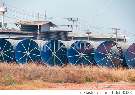 Steel Large  diameter pipes are stacked in an industrial factory at construction site.  136308328