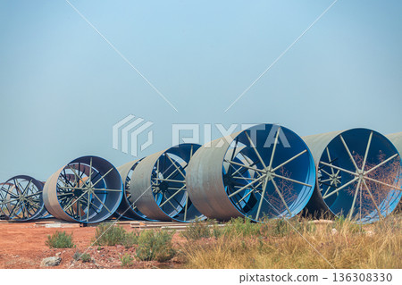 Steel Large diameter pipes are stacked in an industrial factory at construction site. Steel Large diameter pipes are stacked in an industrial factory at construction site. 136308330
