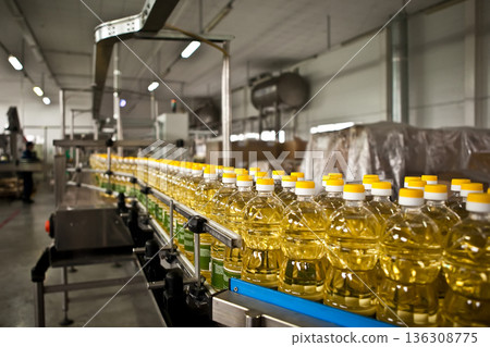 Automated production line bottling golden sunflower oil in a modern food manufacturing plant Automated production line bottling golden sunflower oil in a modern food manufacturing plant 136308775