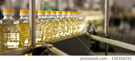 Automated production line bottling golden sunflower oil in a modern food manufacturing plant Automated production line bottling golden sunflower oil in a modern food manufacturing plant 136308781