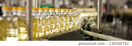 Automated production line bottling golden sunflower oil in a modern food manufacturing plant Automated production line bottling golden sunflower oil in a modern food manufacturing plant 136308782