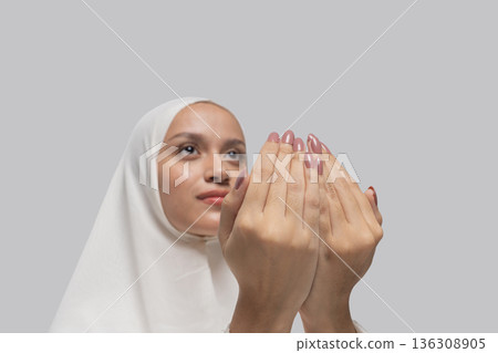 Focused individual wearing headscarf in peaceful meditation 136308905