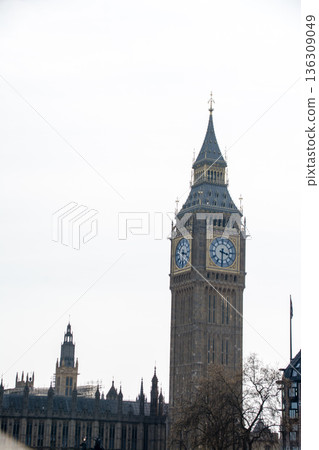 Westminster and Big Ben, the large clock tower in London, under a slightly cloudy sky Westminster and Big Ben, the large clock tower in London, under a slightly cloudy sky 136309049