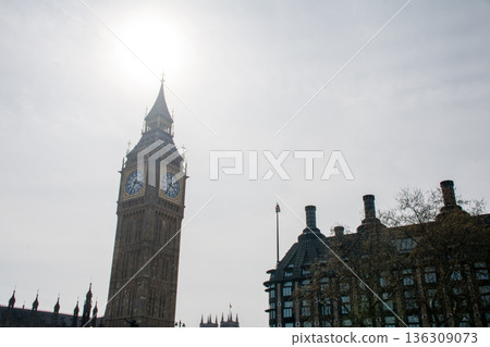 London's Westminster and its large clock tower, Big Ben, backlit under a slightly cloudy sky London's Westminster and its large clock tower, Big Ben, backlit under a slightly cloudy sky 136309073