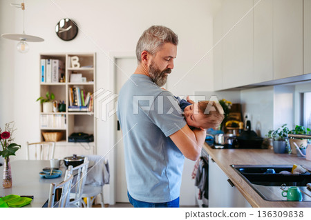 Dad comforting ill child with flu symptoms. 136309838