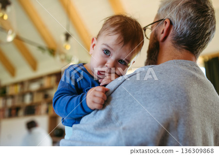 Dad comforting ill child with flu symptoms. 136309868