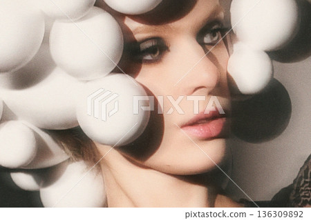 Woman wearing avant-garde headpiece with white spheres Woman wearing avant-garde headpiece with white spheres 136309892