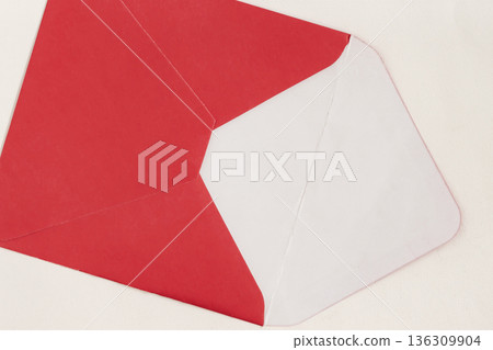 Open red envelope with white interior isolated on light background, minimal flat lay composition, copy space for text. Concept of mail delivery, invitation mockup, background for communication design Open red envelope with white interior isolated on light background, minimal flat lay composition, copy space for text. Concept of mail delivery, invitation mockup, background for communication design 136309904