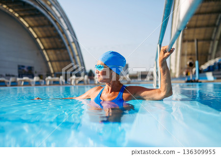 Elderly woman enjoying sport swimming for vitality and longevity. 136309955