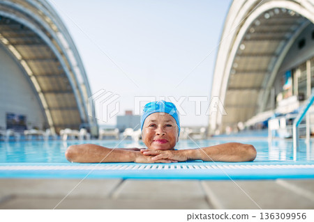 Elderly woman enjoying sport swimming for vitality and longevity. 136309956