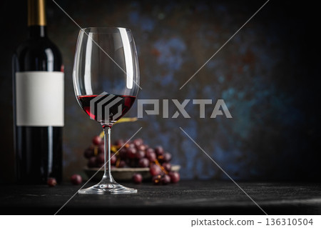 Red Wine in a Glass with Bottles and Grapes Red Wine in a Glass with Bottles and Grapes 136310504