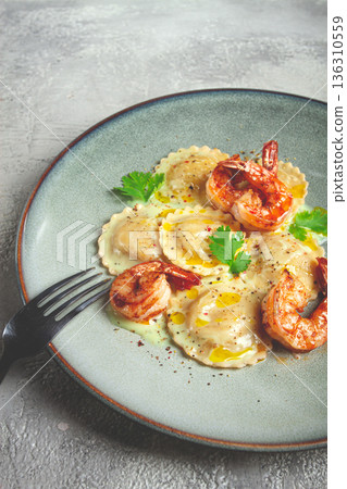 ravioli with shrimp, in cream sauce, with spices and herbs, top view, no people, 136310559