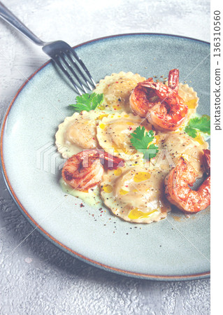 ravioli with shrimp, in cream sauce, with spices and herbs, top view, no people, 136310560