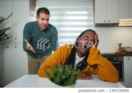 Frustrated man arguing with indifferent woman rolling eyes Frustrated man arguing with indifferent woman rolling eyes 136310880
