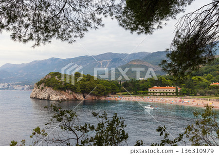 A tranquil coastal scene featuring a rocky coast 136310979