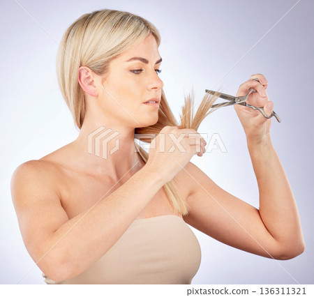 Salon, hair care and woman cutting hair or grooming as diy, beauty and haircut isolated in studio gray background. Person, texture and female model trim tips for hairstyle with a change and growth Salon, hair care and woman cutting hair or grooming as diy, beauty and haircut isolated in studio gray background. Person, texture and female model trim tips for hairstyle with a change and growth 136311321