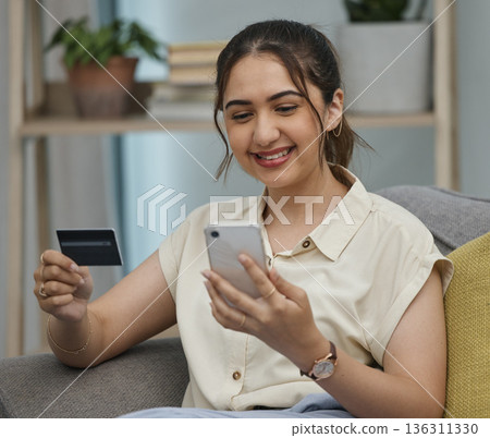 Happy woman, credit card and online shopping on smartphone in home for digital payment, fintech or money transfer. Female, mobile banking and finance of cash, web sales and password for financial app Happy woman, credit card and online shopping on smartphone in home for digital payment, fintech or money transfer. Female, mobile banking and finance of cash, web sales and password for financial app 136311330