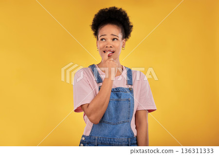 Question, thinking and woman with anxiety, nervous and decision against a yellow studio background. Female person, why and model confused, anxious and biting nails with depression, stress and fear Question, thinking and woman with anxiety, nervous and decision against a yellow studio background. Female person, why and model confused, anxious and biting nails with depression, stress and fear 136311333