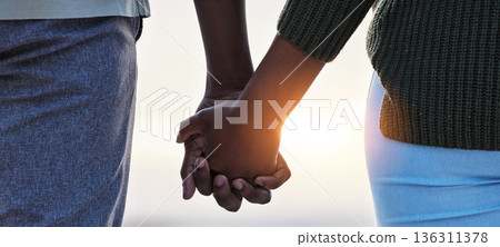 Holding hands, couple and love outdoor at the beach with care, trust and commitment. Closeup of a man and woman relax together on vacation, holiday or sunset travel adventure in nature for freedom Holding hands, couple and love outdoor at the beach with care, trust and commitment. Closeup of a man and woman relax together on vacation, holiday or sunset travel adventure in nature for freedom 136311378