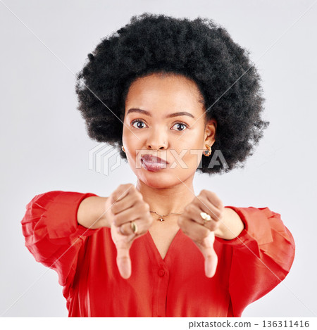 Thumbs down, portrait and hands of black woman in studio reject bad news, emoji sign and feedback on white background. Face of female model show negative review, wrong decision or vote no for failure 136311416