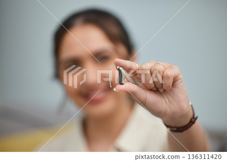 Hearing aid, hands and person with disability for medical support, listening and healthcare innovation. Closeup of deaf female patient with audiology implant to help sound waves, amplifier and volume 136311420