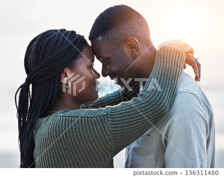 Couple, beach and touch forehead outdoor for love, care and commitment. Profile of a young black man and a happy woman together on a romantic vacation, holiday or sunset travel adventure in Jamaica Couple, beach and touch forehead outdoor for love, care and commitment. Profile of a young black man and a happy woman together on a romantic vacation, holiday or sunset travel adventure in Jamaica 136311480