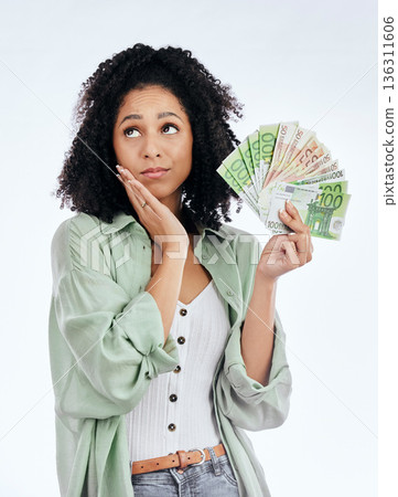 Woman, money fan and thinking in studio for prize, profit or bonus from investing, savings or notes by white background. Isolated African girl, student and decision for cash, win or gambling in lotto Woman, money fan and thinking in studio for prize, profit or bonus from investing, savings or notes by white background. Isolated African girl, student and decision for cash, win or gambling in lotto 136311606