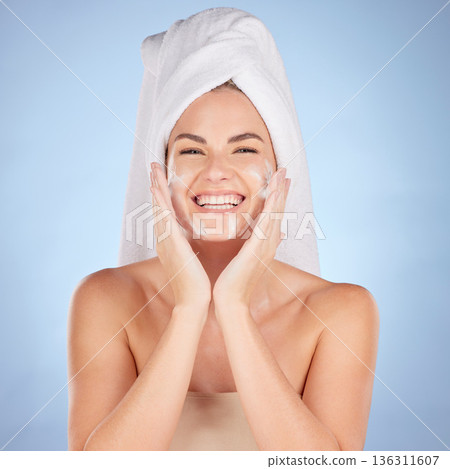 Shower, portrait and woman washing face with soap in studio, blue background and cleaning cosmetics. Happy female model, facial skincare and foam for healthy glow, dermatology and moisturizing beauty 136311607