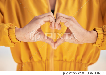 Woman, heart hands and love for care, support or trust in healthcare, romance or gesture. Closeup of female person with emoji, symbol or icon for health, like or wellness in peace, sign or emoticon 136311610