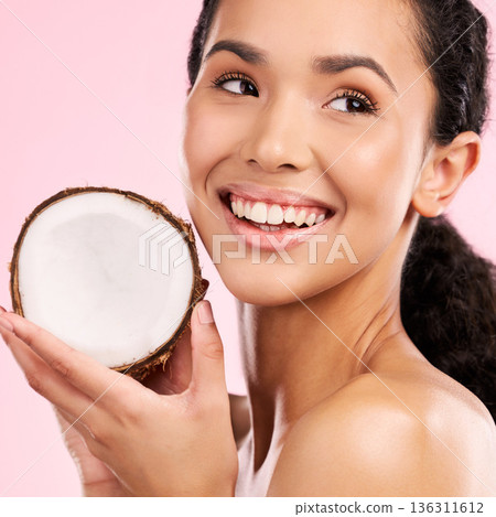 Coconut, fruit and woman thinking of skincare, beauty or vegan cream on a pink, studio background. Young african person with natural product idea for dermatology and healthy cosmetics or oil benefits 136311612