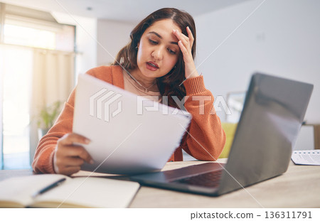 Documents, stress and woman on laptop in home with paperwork for online banking, finance and taxes. Remote work, worry and female person with computer for debt payment, financial report and bills Documents, stress and woman on laptop in home with paperwork for online banking, finance and taxes. Remote work, worry and female person with computer for debt payment, financial report and bills 136311791