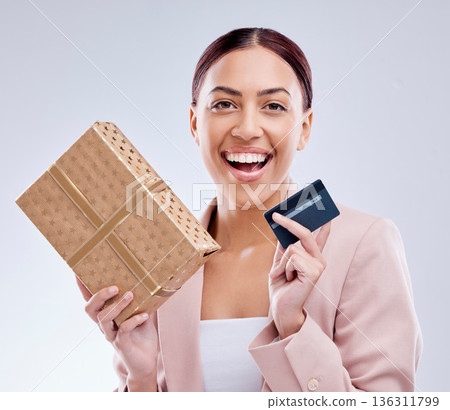Woman, credit card and gift box for prize, retail giveaway or payment success on studio white background. Happy person or winner portrait with present, finance bonus and shopping sale and e commerce Woman, credit card and gift box for prize, retail giveaway or payment success on studio white background. Happy person or winner portrait with present, finance bonus and shopping sale and e commerce 136311799