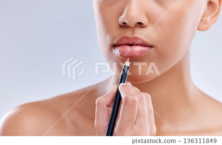 Makeup, mouth and woman with lip pencil in studio for beauty, cosmetics and color on grey background. Liner, filling and hand of female model with beauty product for glamour, routine or application Makeup, mouth and woman with lip pencil in studio for beauty, cosmetics and color on grey background. Liner, filling and hand of female model with beauty product for glamour, routine or application 136311849