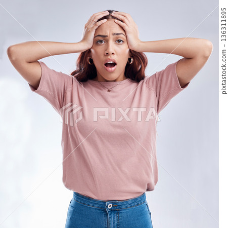 Woman with hands on head, surprise and stress, reaction in portrait with disaster isolated on white background. Crisis, mistake and fail, female person with problem and wow expression in a studio 136311895