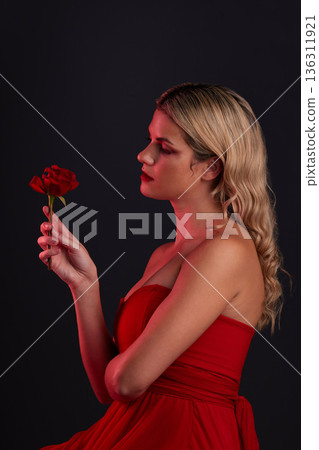 Beauty, fashion and woman with a rose on a dark, black background in a studio thinking of love, romance or red aesthetic. Girl with a flower, dress and formal style in fantasy, fairytale or art Beauty, fashion and woman with a rose on a dark, black background in a studio thinking of love, romance or red aesthetic. Girl with a flower, dress and formal style in fantasy, fairytale or art 136311921