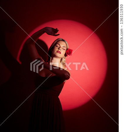 Vintage, creative and a woman in a spotlight on a studio background for an art aesthetic. Fashion, retro and a young girl or rich model in a stylish dress or clothes isolated on a red backdrop 136311930