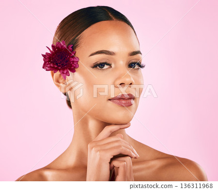 Skincare, beauty and portrait of woman with flower, makeup and organic glow on pink background. Cosmetics, natural dermatology and model with facial care, nature and healthy spa aesthetic in studio. 136311968