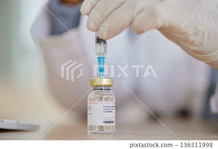 Smallpox vaccine, vial and hands of doctor for safety, healthcare or medicine in hospital. Closeup, nurse and prepare vaccination, virus injection and bottle for immunity, medical development or help 136311998