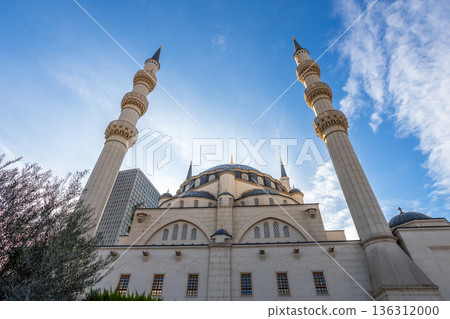 Large white Great Mosque building with minarets representing modern Islamic religious architecture with blue sky in the background, Tirana, Albania 136312000