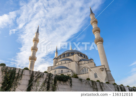 Large white Great Namazgah Mosque building with minarets representing modern Islamic religious architecture with park and blue sky in the background, Tirana, Albania Large white Great Namazgah Mosque building with minarets representing modern Islamic religious architecture with park and blue sky in the background, Tirana, Albania 136312018
