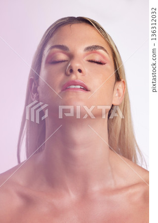 Face, beauty and skincare with a model woman in studio on a gray background in ambient lighting for feminine desire. Luxury, makeup or cosmetics with a young person posing eyes closed for wellness Face, beauty and skincare with a model woman in studio on a gray background in ambient lighting for feminine desire. Luxury, makeup or cosmetics with a young person posing eyes closed for wellness 136312032