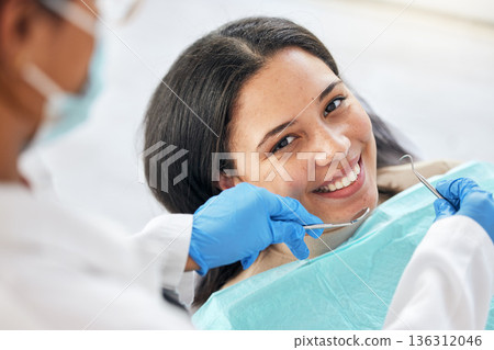 Dentist, dental care and teeth smile of a woman with tools and hands of a professional by mouth. Portrait of a female patient for orthodontics, healthcare and cleaning or inspection for oral health Dentist, dental care and teeth smile of a woman with tools and hands of a professional by mouth. Portrait of a female patient for orthodontics, healthcare and cleaning or inspection for oral health 136312046
