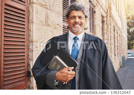 Portrait, judge or lawyer in city with legal books, constitution or research on policy, rules or knowledge on justice in court. Attorney, man with success or working with expert on government laws 136312047