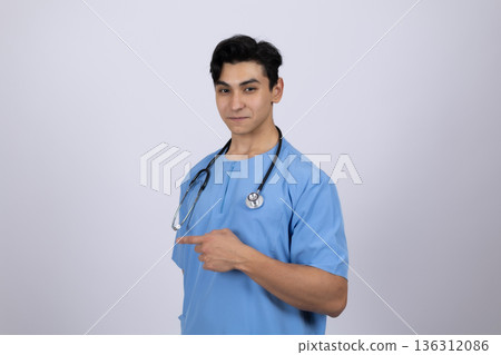 Professional male doctor in blue medical scrubs posing 136312086